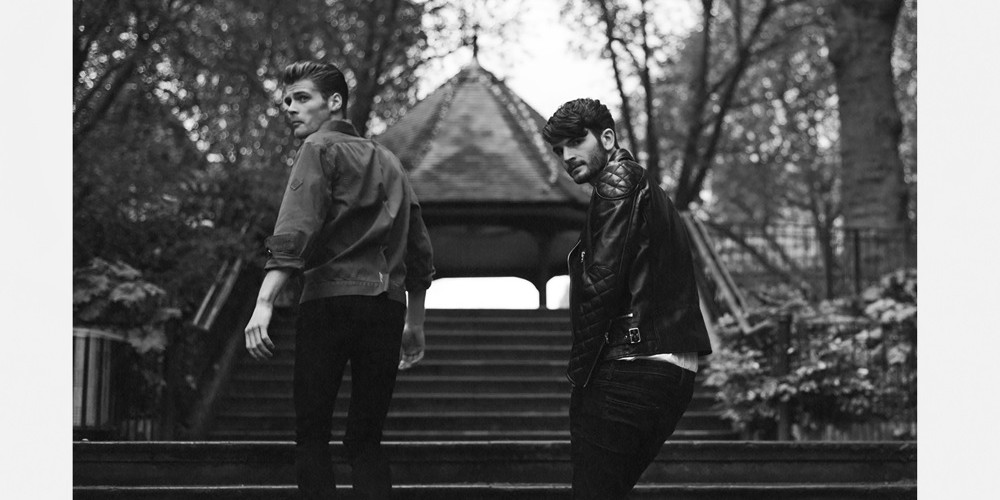 Black And White Portrait Of Two Men Walking Up Stairs To Garden In East London