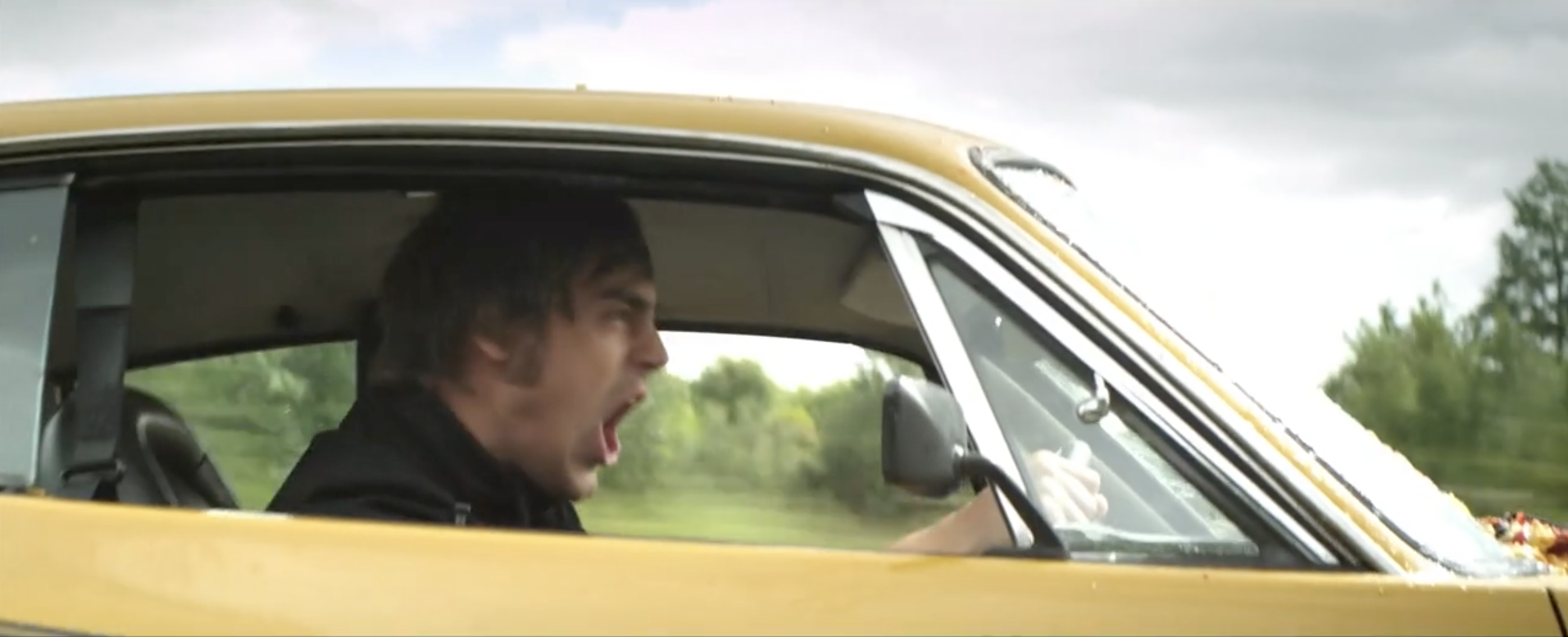 Man Driving Yellow American Muscle Car Aggressively Shouting