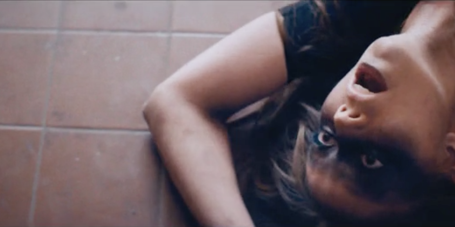 Woman Laying On Bathroom Floor With Mouth And Eyes Open