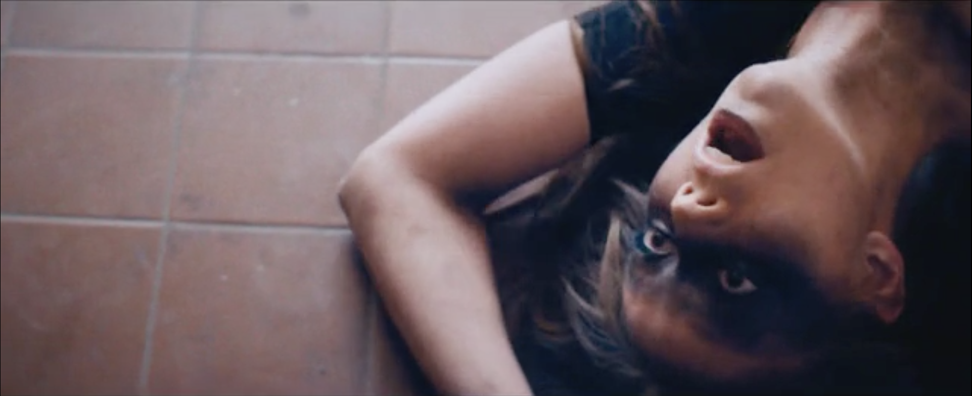 Woman Laying On Bathroom Floor With Mouth And Eyes Open