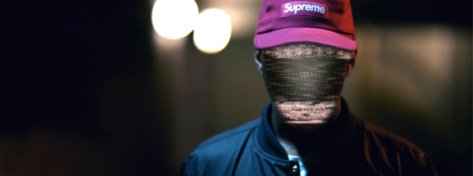 British DJ Shy FX Standing In Supreme Hat And Blue Bomber Jacket In Dark Alley
