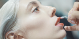 Fashion film and event video production showcasing behind-the-scenes makeup application backstage at a runway show.