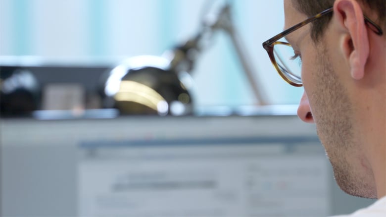 Man Sitting At Desk Coding