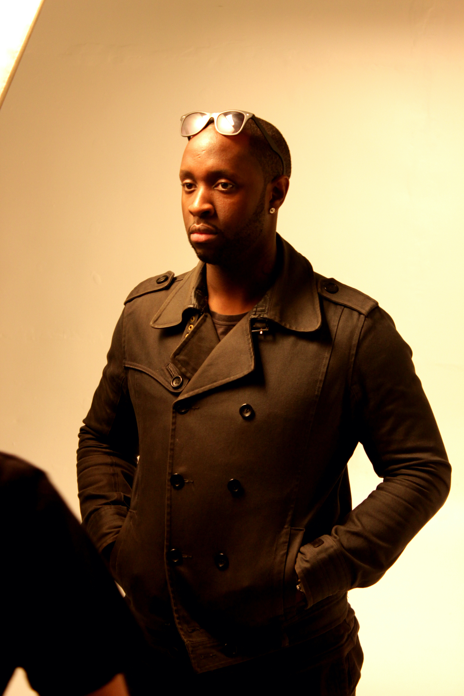 Professional Photography Closeup Of Black Man In Khaki Suite Standing On White Studio Backdrop With Lighting Stands