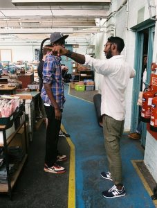 Professional Photography Black And Asian Man Discussing Filming In Grenson Shoe Factory With Cameraman