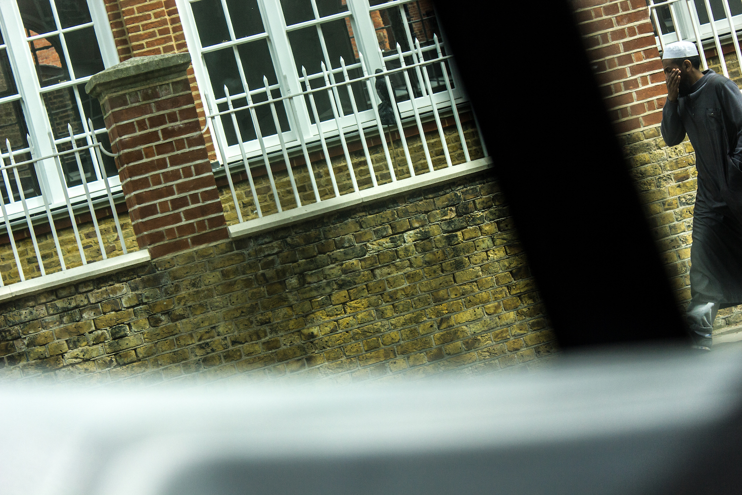 Professional Photography Muslim Man In Traditional Garments Stroking Beard Walking In Bethnal Green After Attending Prayer