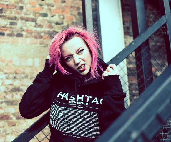 Professional Photography White Woman With Pink Hair Wearing Black Hashtagee Generals Streetwear Hoodie Standing On Black Fire-escape Stairs