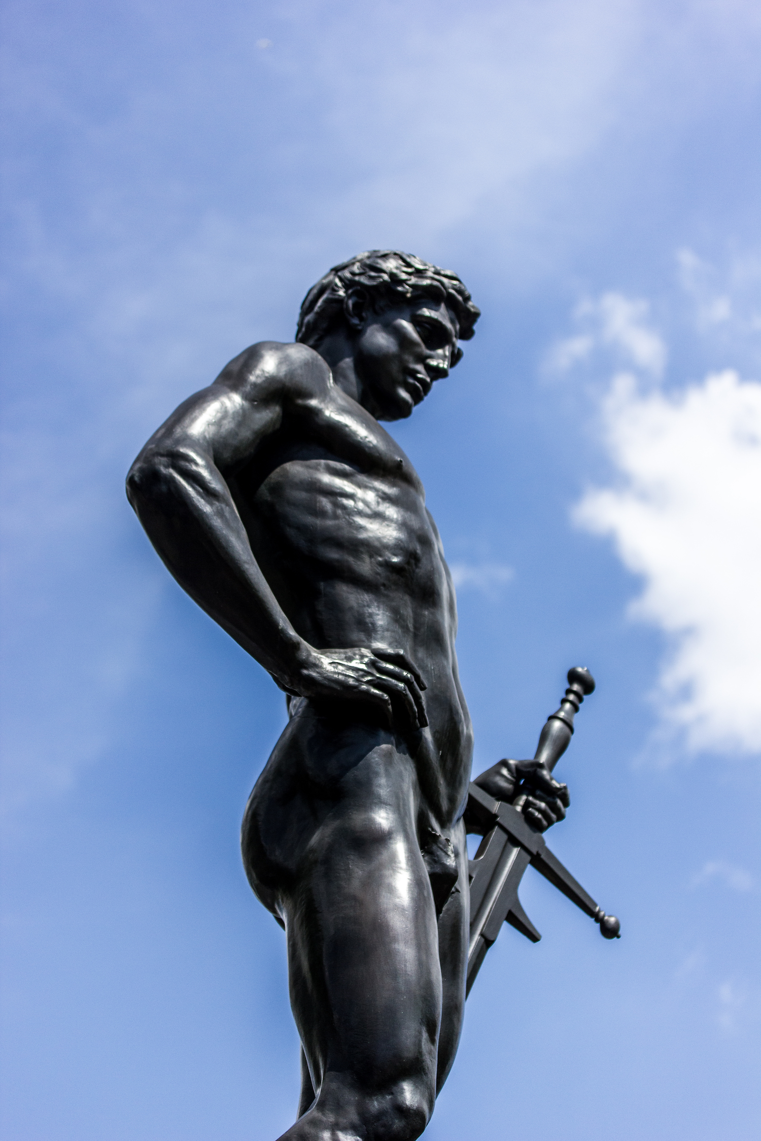 Professional Photography Black Statue Of Man With Sword And Hand On Hip Blue Sky And Clouds In Hyde Park London