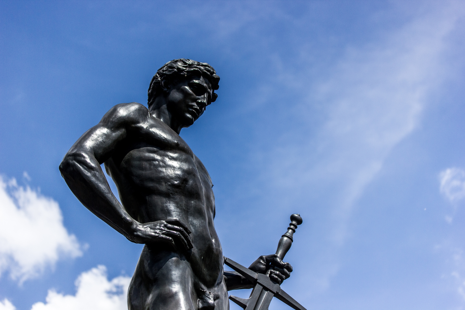 Professional Photography Black Statue Of Man With Sword And Hand On Hip Blue Sky And Clouds In Hyde Park London