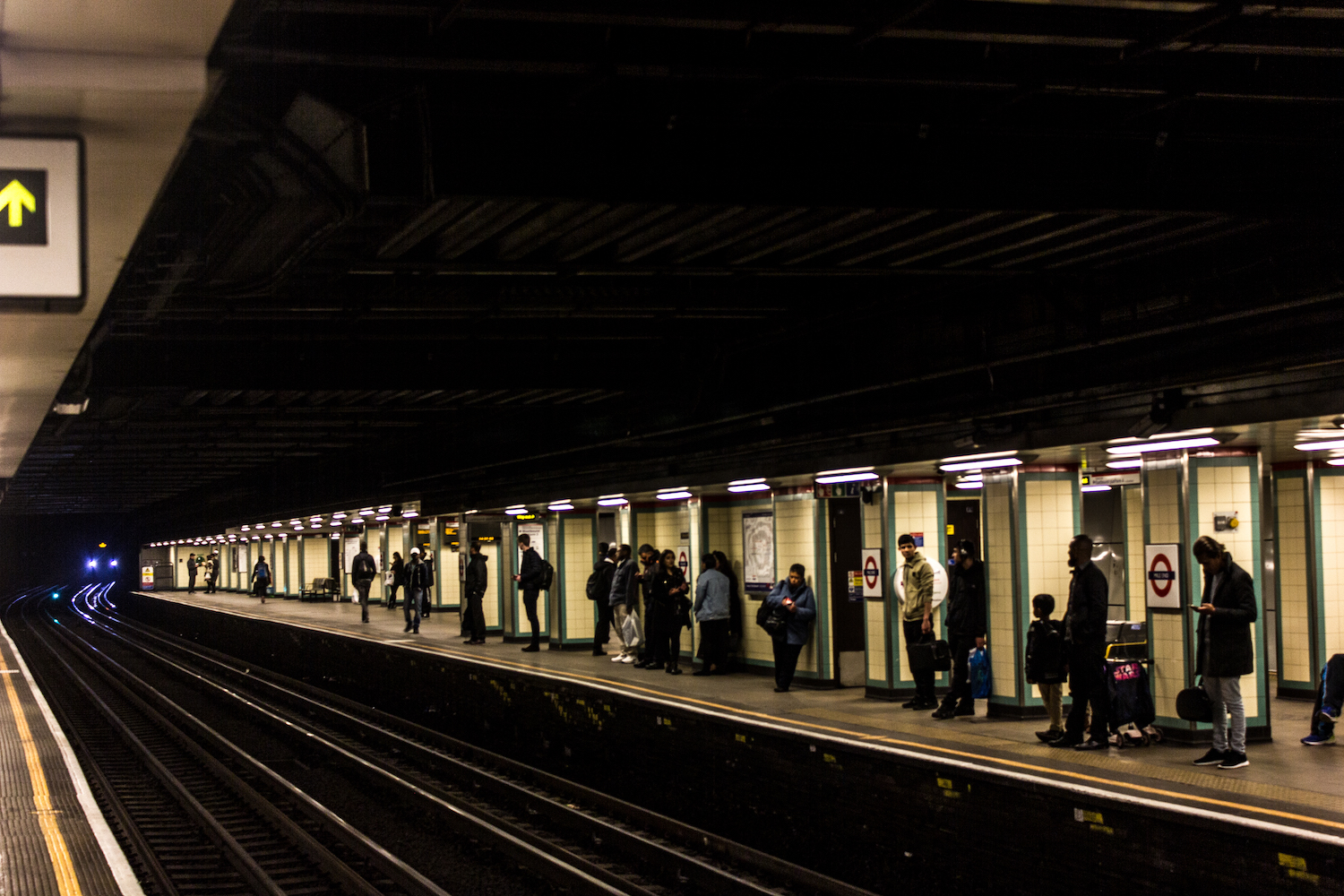 Professional Photography People Waiting On Train Platform As Train Approaches In Mile End Train Station London