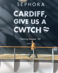 a man walking past a Sephora coming soon sign in St Davids Dewi Sant, Cardiff
